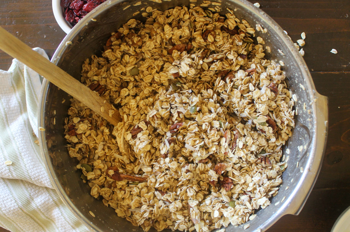 A large mixing bowl with granola ready to bake.