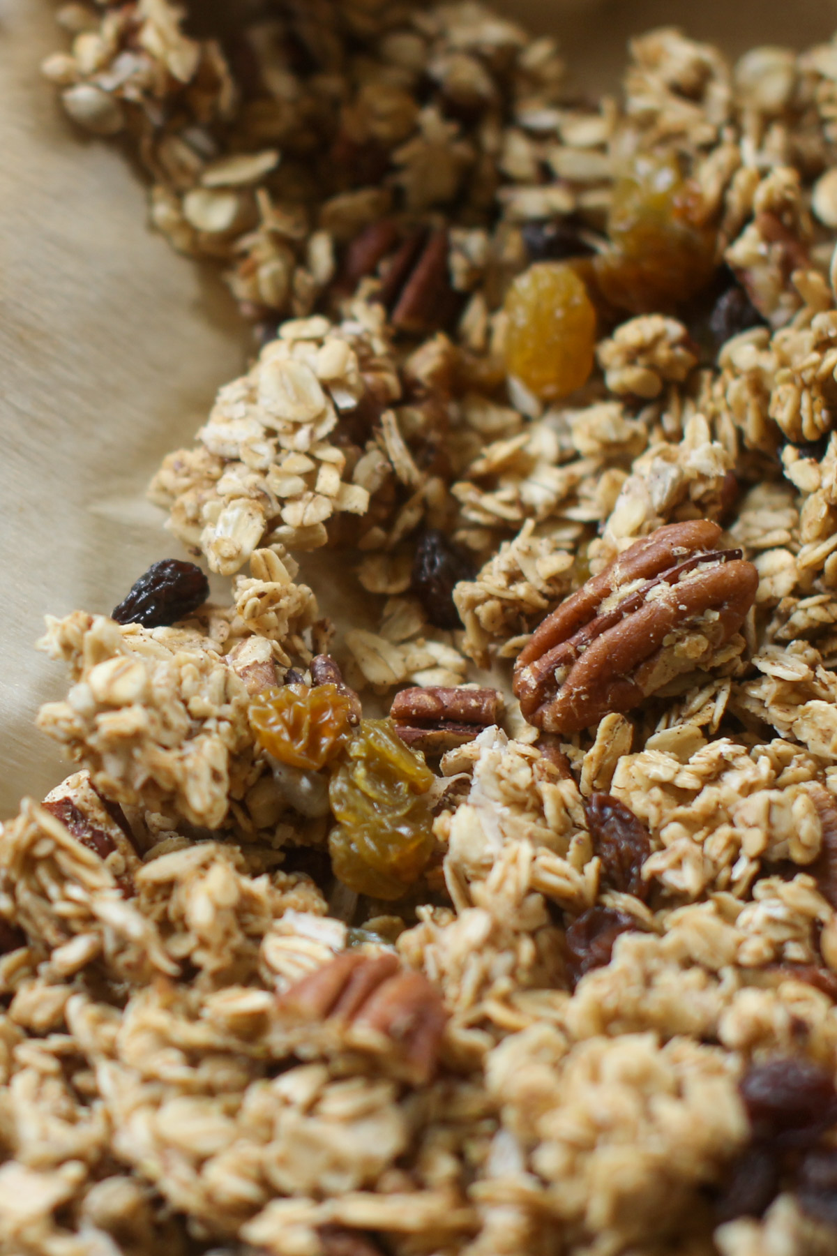 Applesauce granola on a sheet pan with parchment paper.