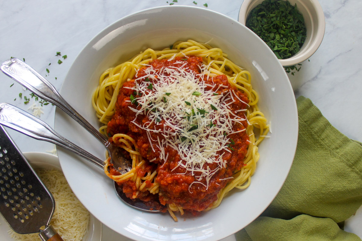 A bowl of spaghetti with Italian Sausage Bolognese tomato sauce.