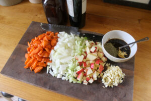 Veggies chopped on a cutting board to add to the searing beef roast.