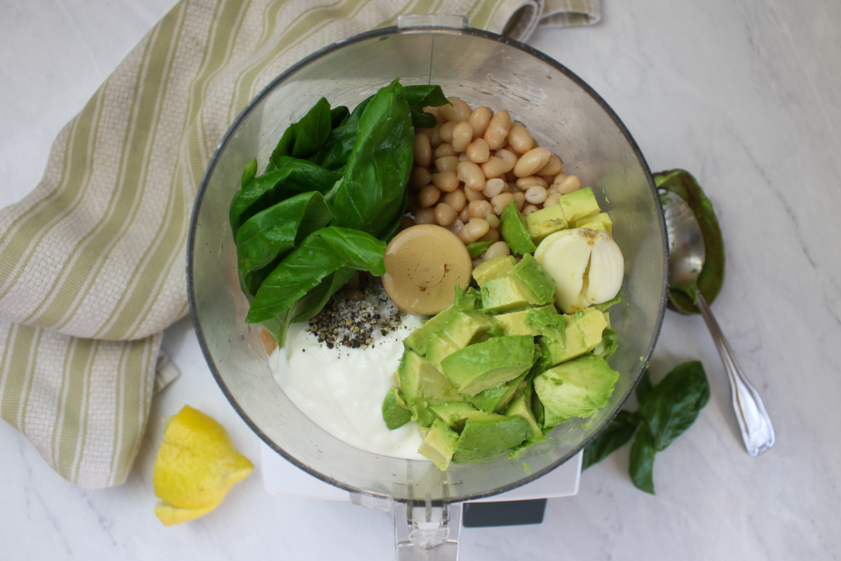 Dip ingredients in the bowl of a food processor ready to blend.