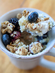 Leftover quinoa breakfast bowl with berries and granola.