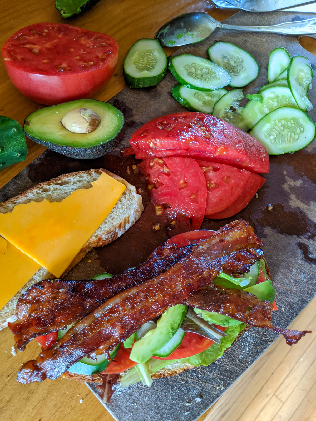 Making a BLT with Avocado and cheese.