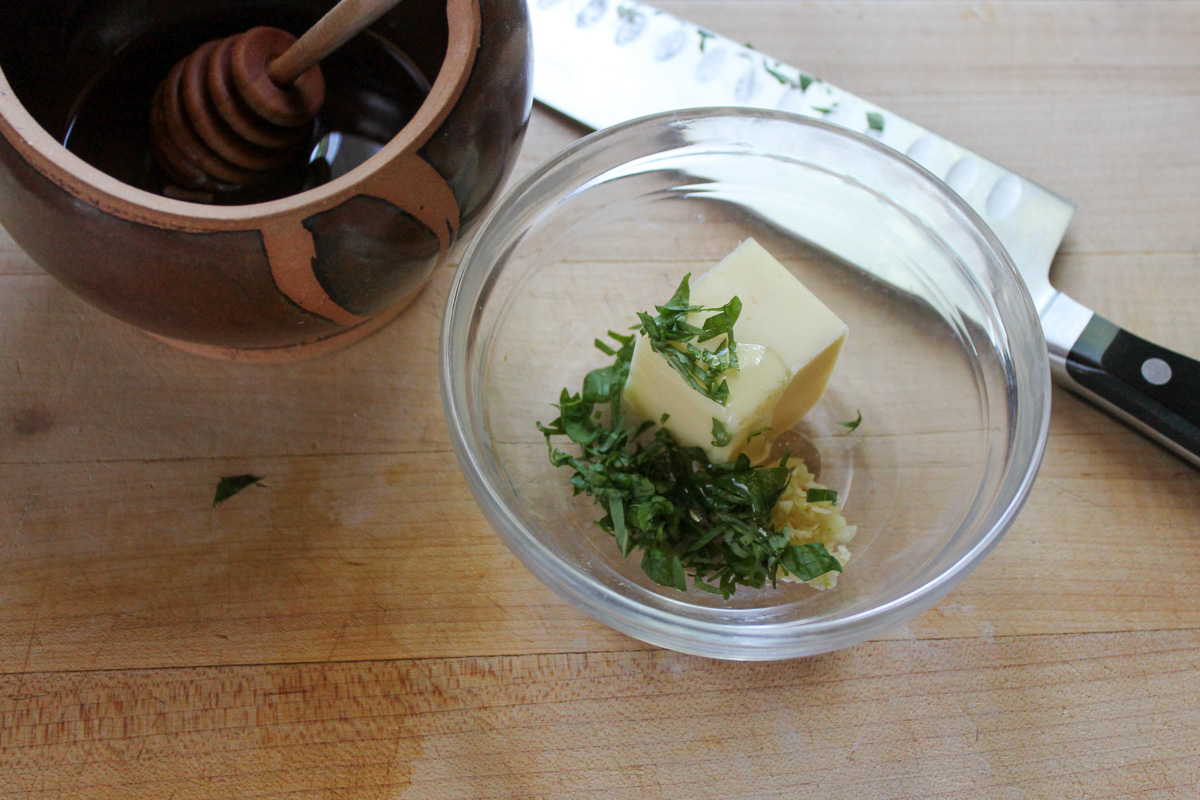 Making Garlic Honey Butter in a small bowl.