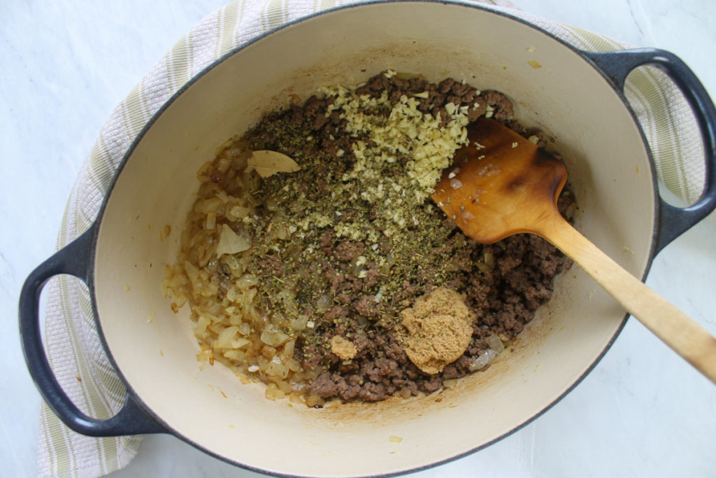 Spaghetti instructions, seasonings added to ground beef and onions.