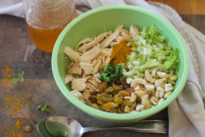 Bowl of cashew curry chicken salad ingredients ready to be mixed.