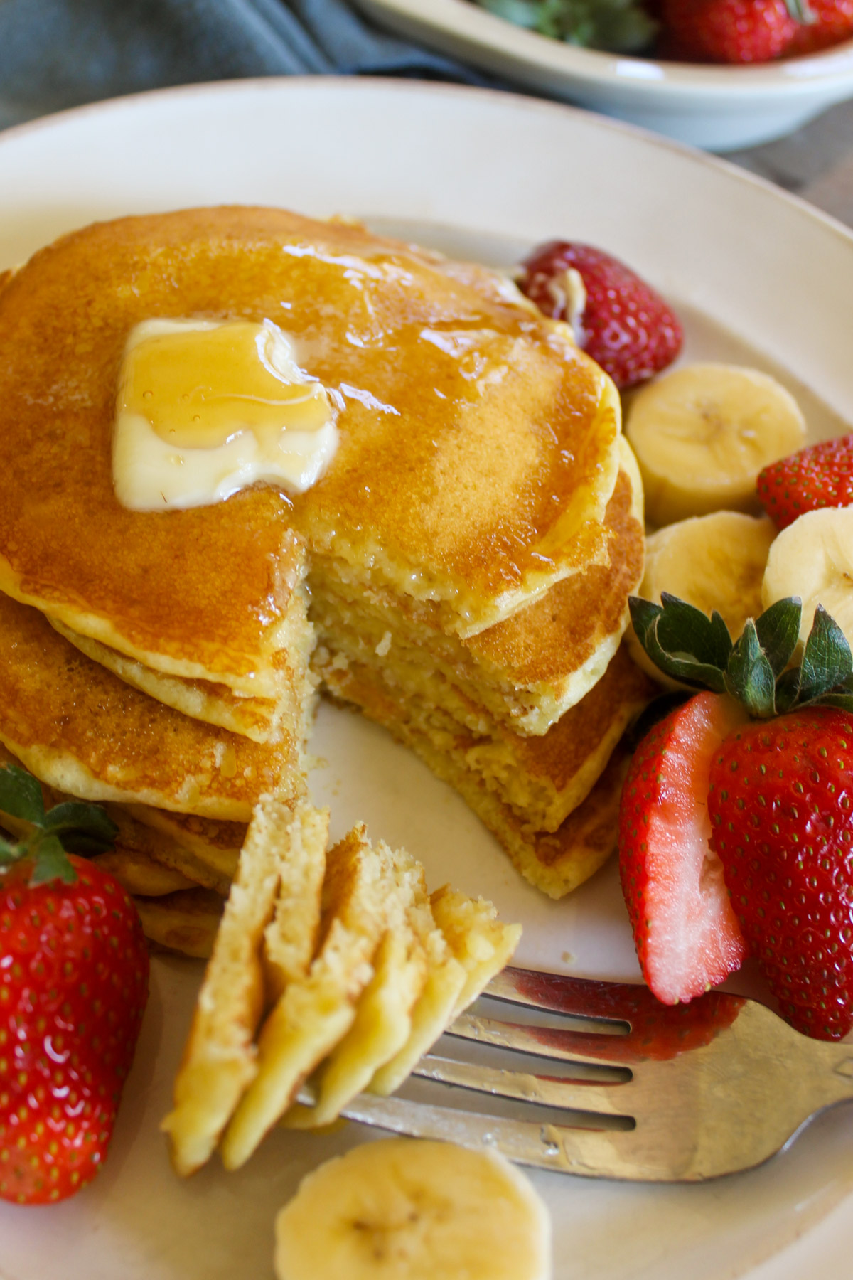 Buttermilk pancakes cut with a fork.