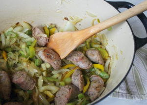 Sautéing Sausage Links with peppers, onions, and fennel.