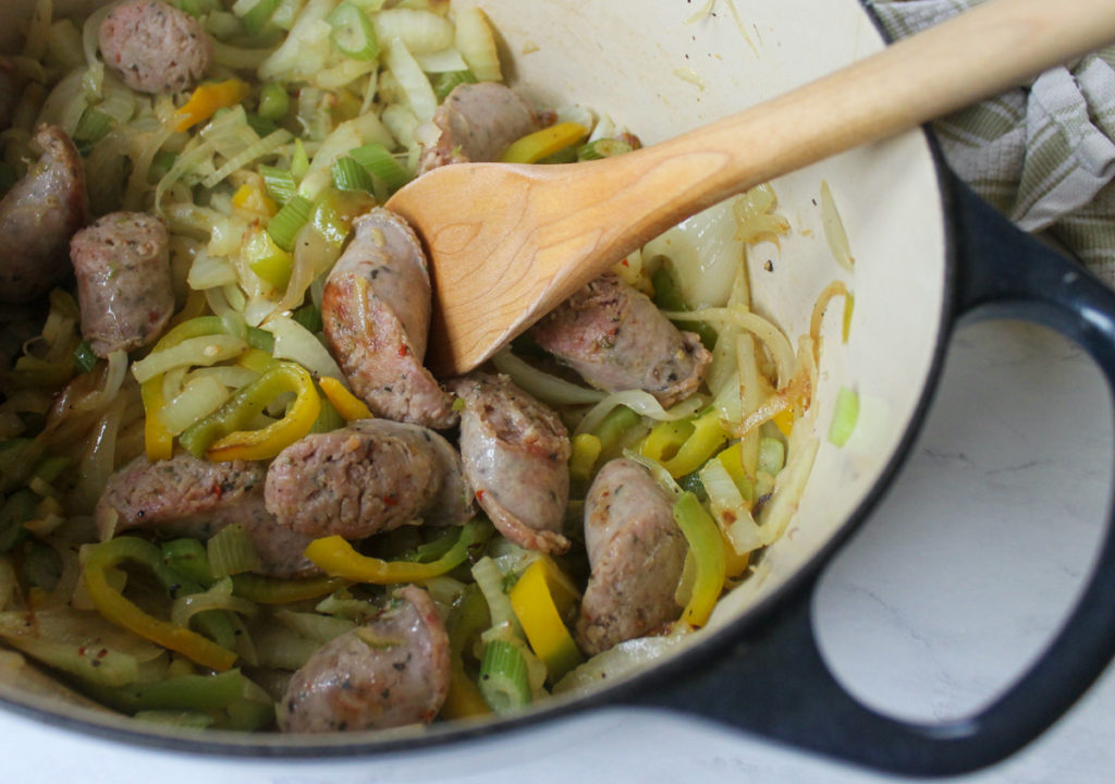 Sautéing Sausage Links with peppers, onions, and fennel.