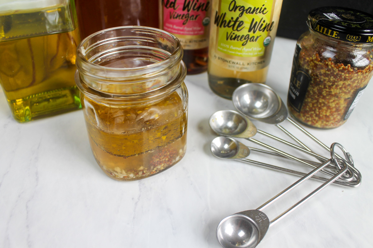 Making honey garlic vinaigrette dressing in a jar.