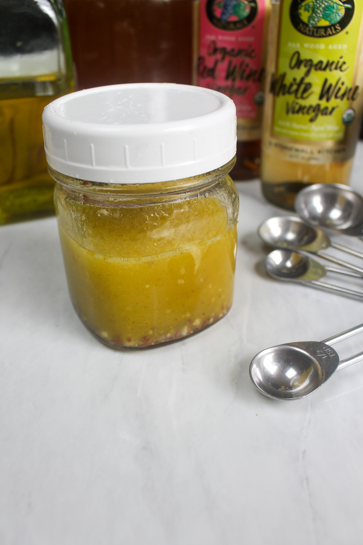 A mason jar salad dressing with a lid.