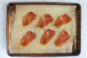 Crispy Prosciutto on a sheet pan with parchment paper.