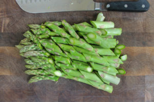 Bias cut asparagus on a cutting board ready to blanch.