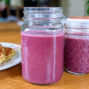 Pink smoothies in mason jars.