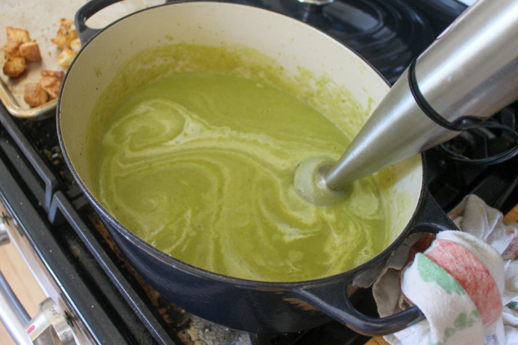 Pureeing asparagus soup with immersion blender.