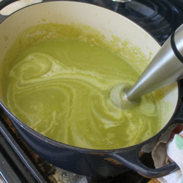 Pureeing asparagus soup with immersion blender.