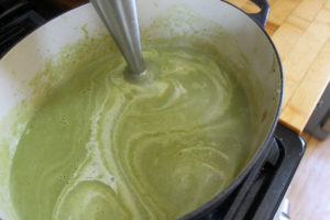 Pureeing asparagus soup with immersion blender.