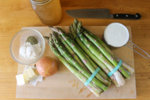 Garden fresh asparagus soup ingredients on a cutting board.