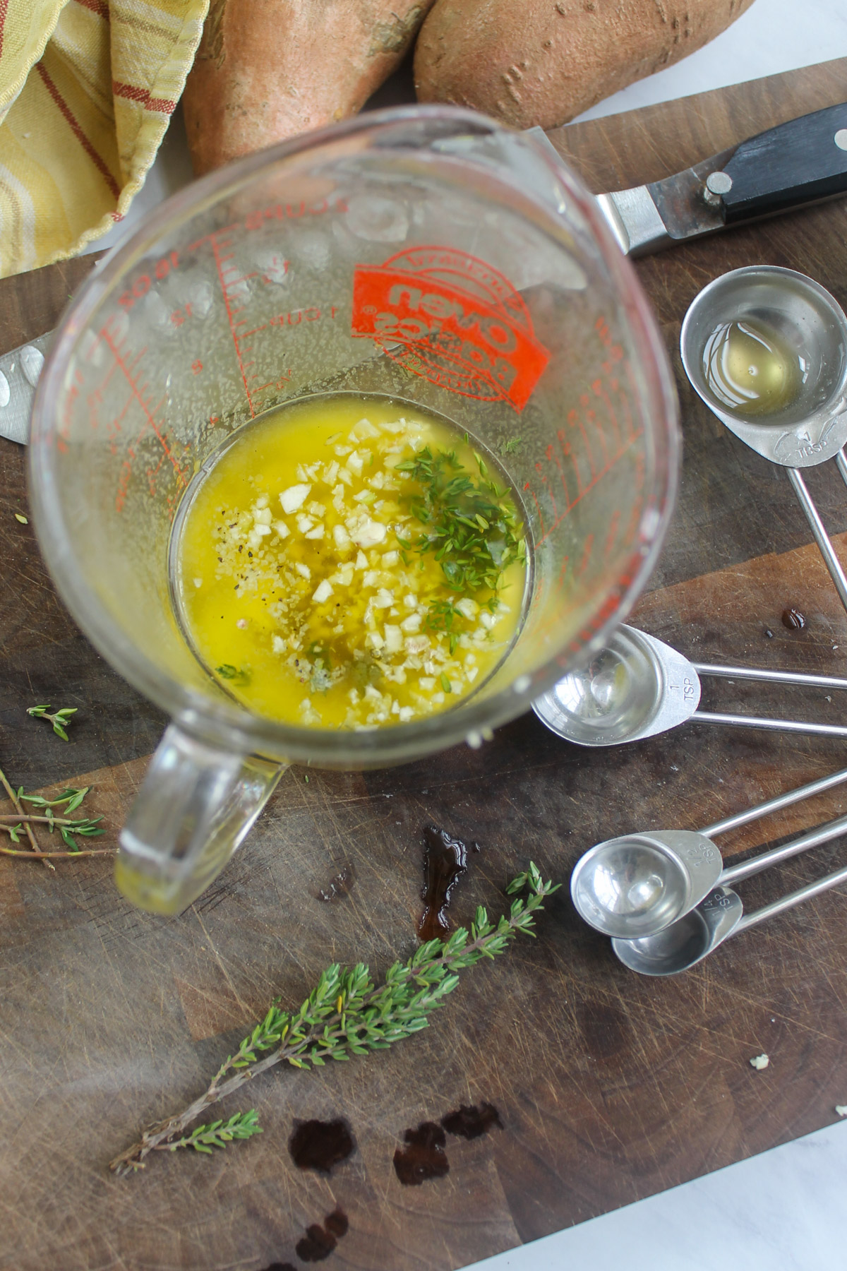 Mixing the garlic honey butter in a glass measuring cup.