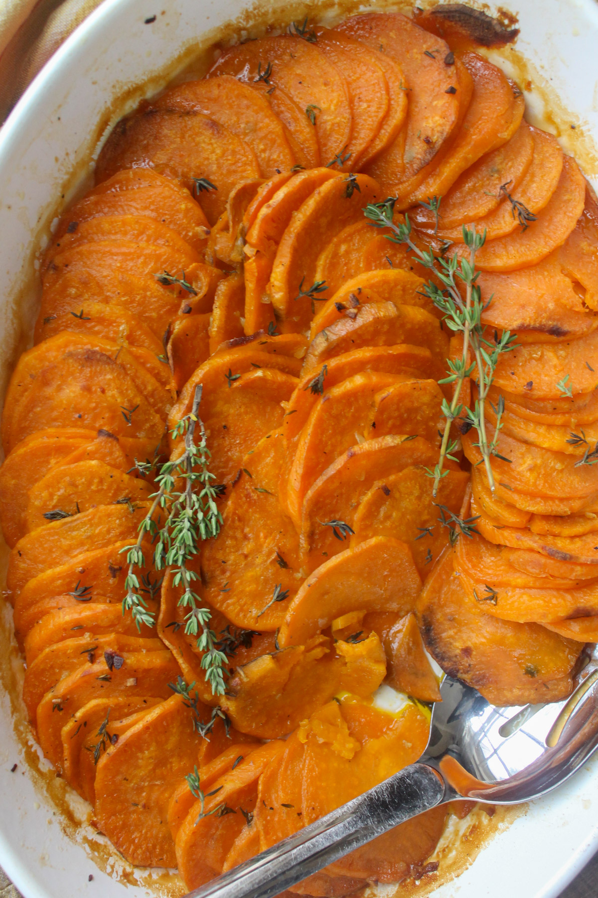 Oven roasted sweet potato slices in garlic honey butter with fresh thyme.