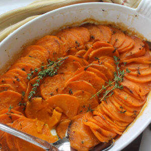 Roasted sweet potato slices in garlic honey butter with fresh thyme.