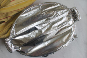 The casserole dish covered in tin foil and ready to bake.