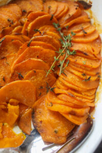 A casserole pan of roasted sweet potato slices for Thanksgiving.
