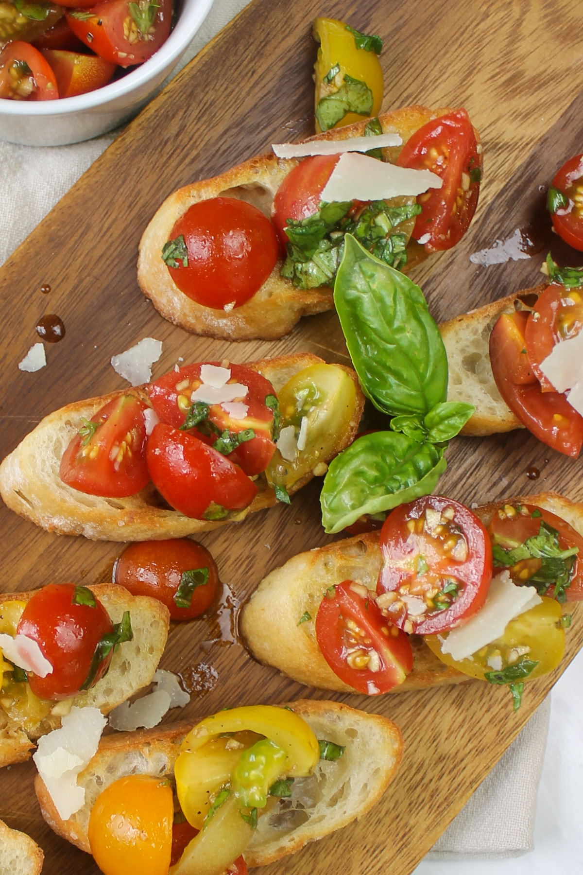 Bruschetta served on sliced baked baguette and topped with Parmesan and basil.
