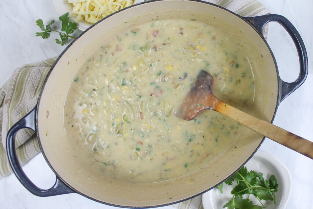 The full Dutch oven pot of finished creamy potato corn chowder soup.