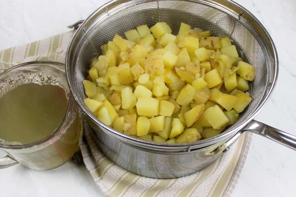 Potatoes for chowder are boiled in a separate pot and drained, saving the starchy cooking liquid to add to the soup.