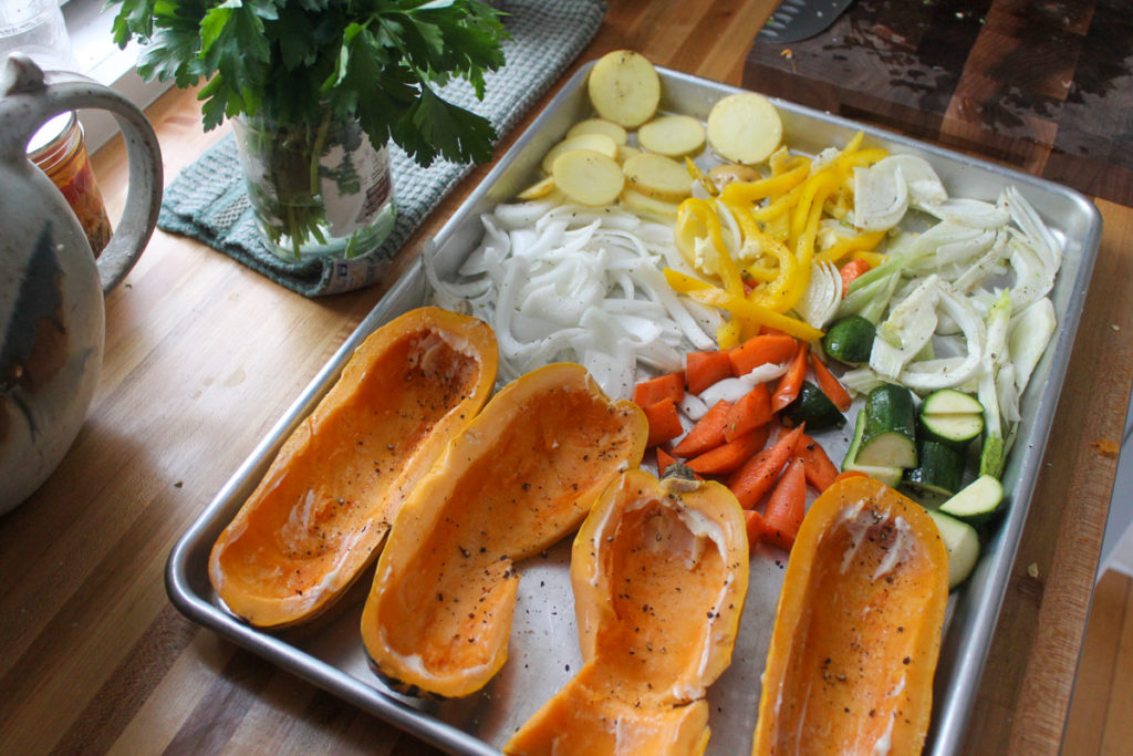 A sheet pan of vegetables ready to roast for flatbread pizza.