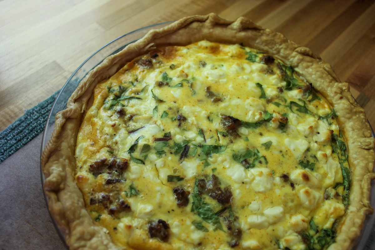 Close up of sausage and spinach baked quiche.