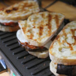 Eggplant Panini on the panini press with marinara and cheese.