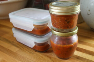 Small containers of spaghetti sauce to freeze for eggplant paninis.