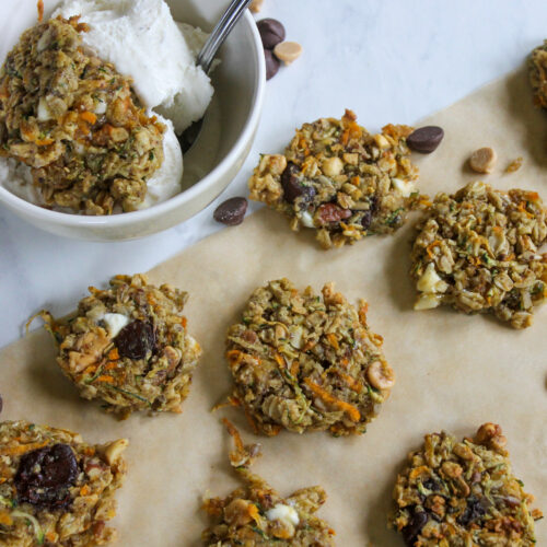 Healthy Zucchini Banana Cookies on parchment paper next to a bowl if cookies and ice cream.