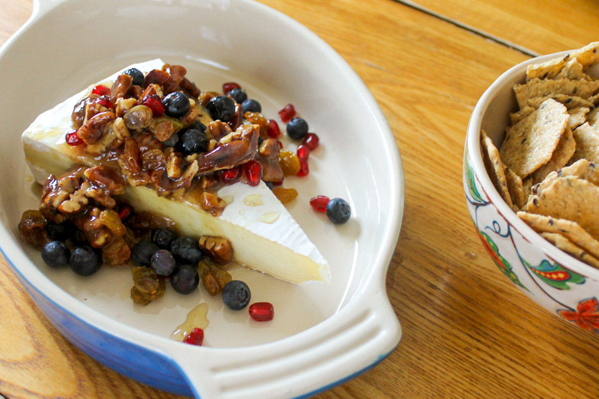 Honey Nut Brie Appetizer with berries and pomegranate seeds.