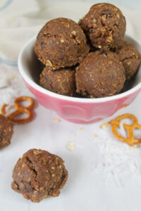 A pink bowl of Nutella Protein Balls made with pretzels.
