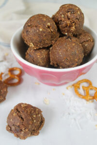 A pink bowl of Nutella Protein Balls made with pretzels.