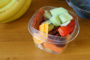 Car snacks for kids with melon, cheese, strawberry, grapes and beef sticks.