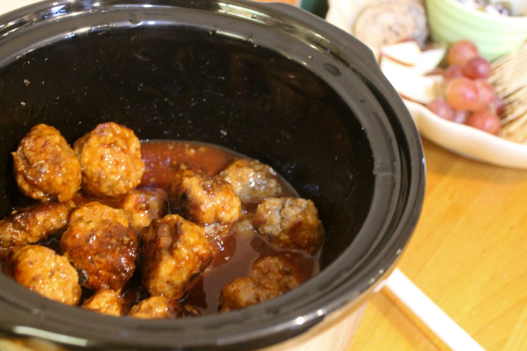 Sweet and Sticky Party Meatballs in a crockpot with sauce.