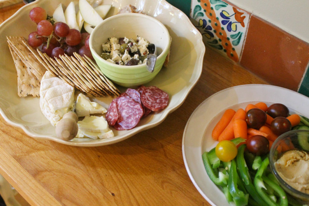 Platters of appetizers with cheese, meats and veggies to serve with crockpot meatballs.