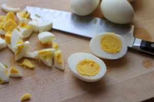 Perfect hard boiled eggs, cut in half to show only yellow and white.