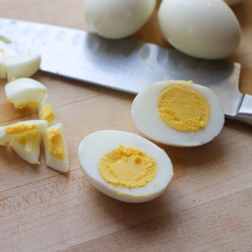A hard boiled egg sliced in half with perfectly cooked yellow yolk and whites.
