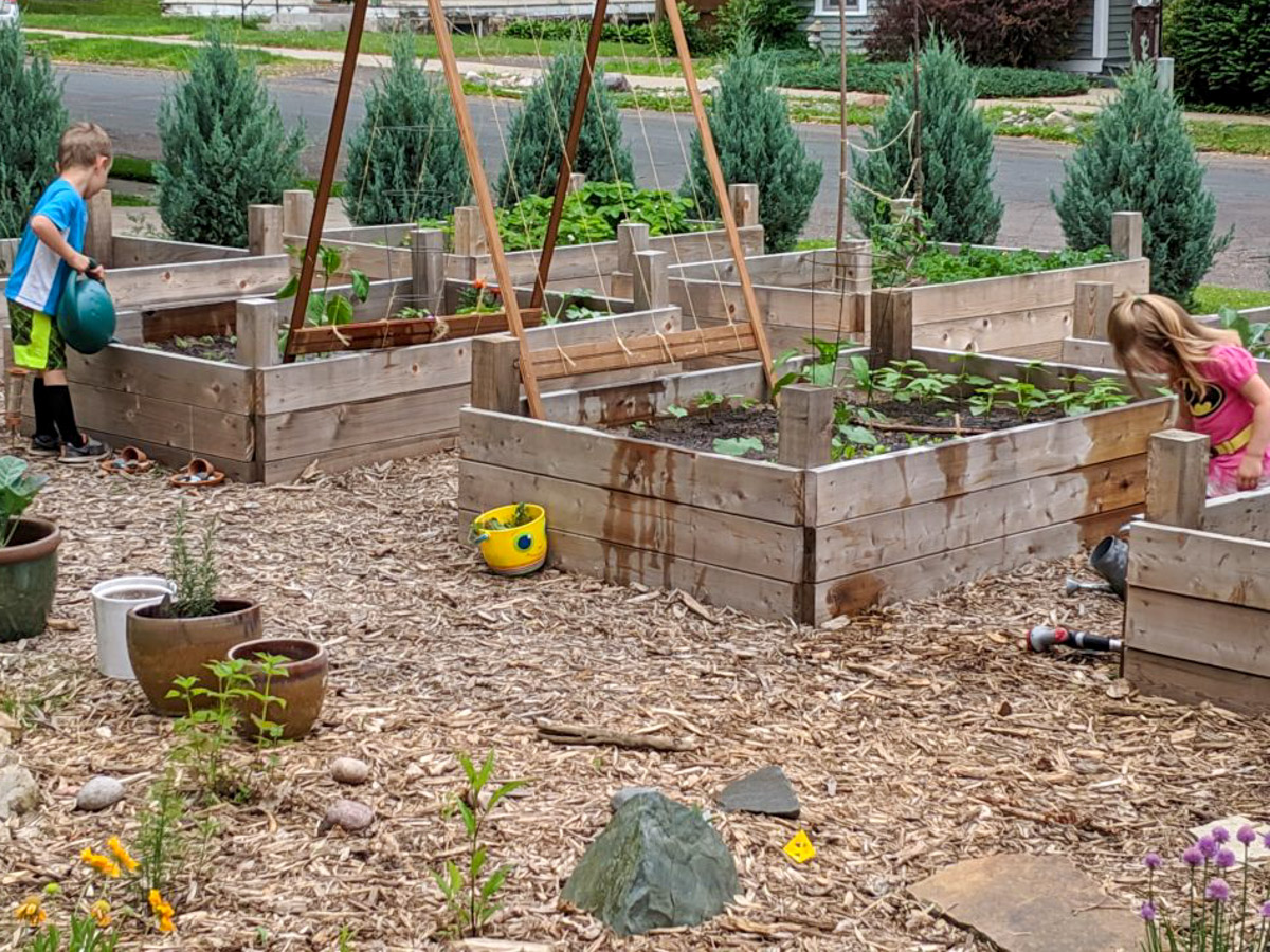 Kids watering the garden.