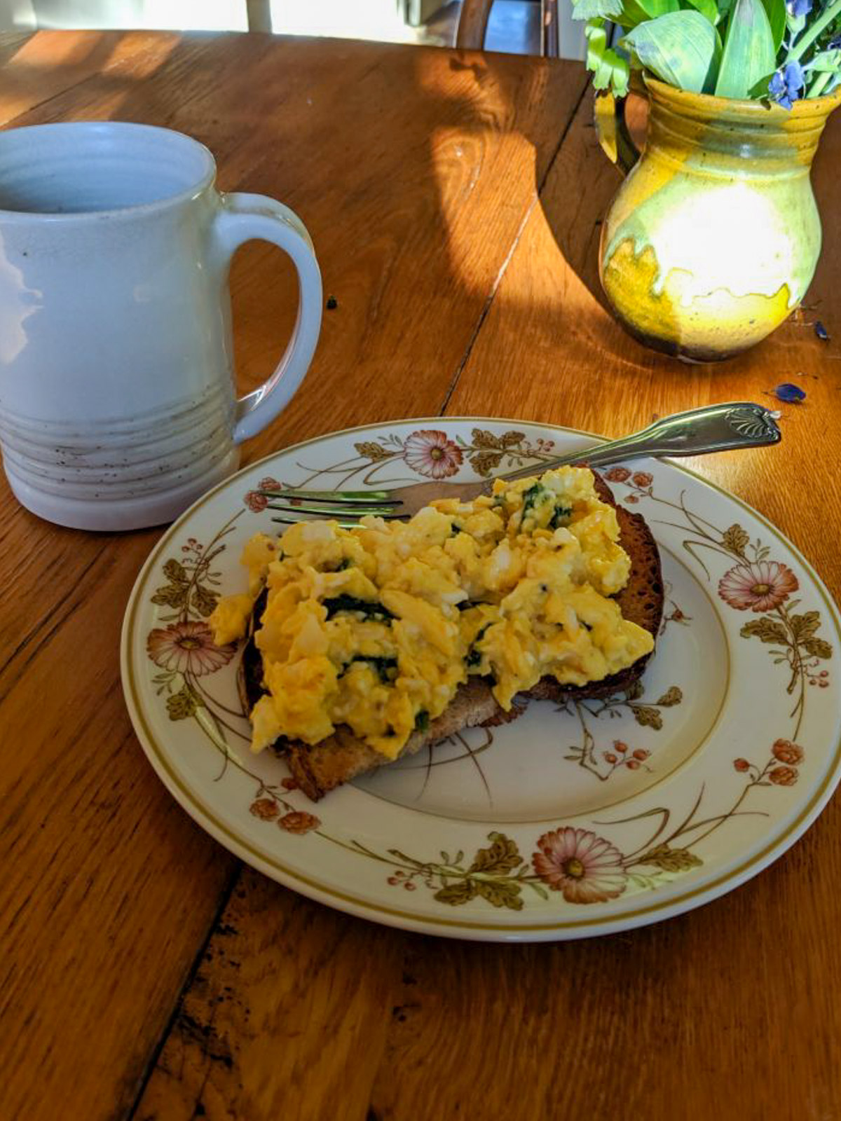 Breakfast with eggs on toast with garden fresh spinach.