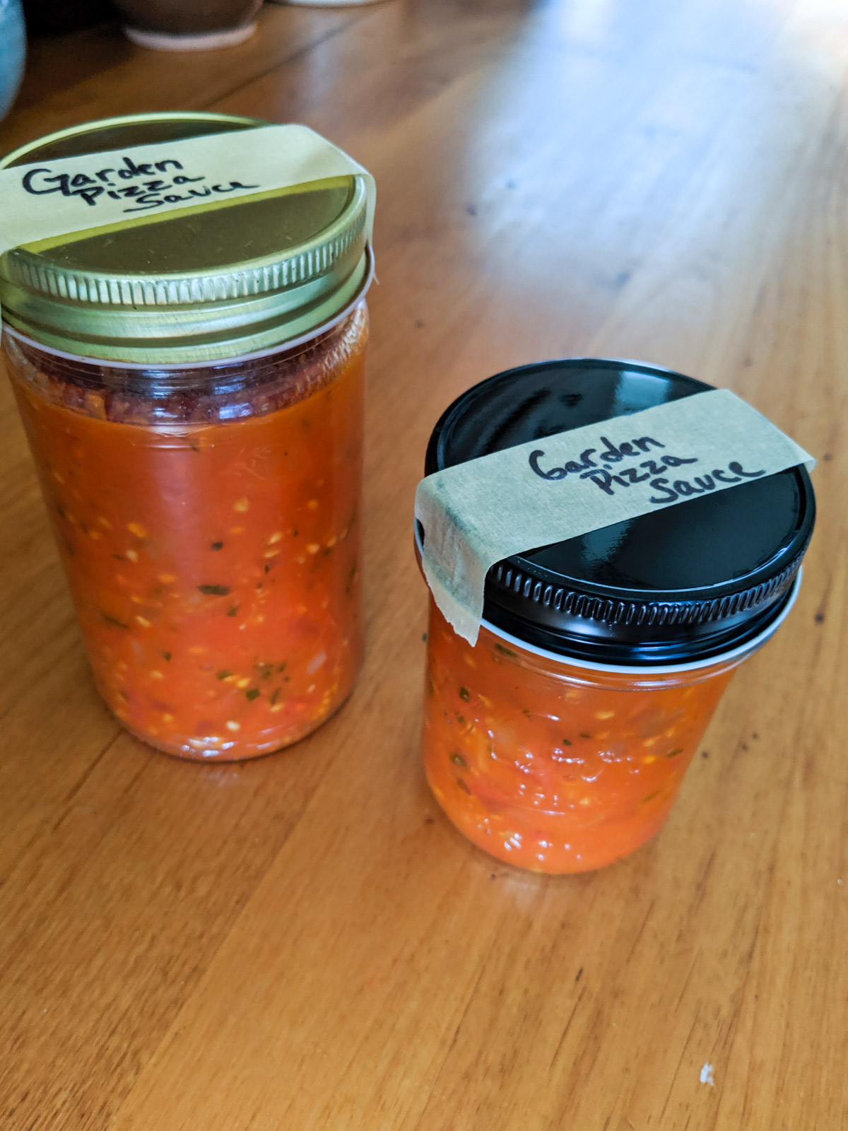 Garden marinara sauce in two jars to freeze.