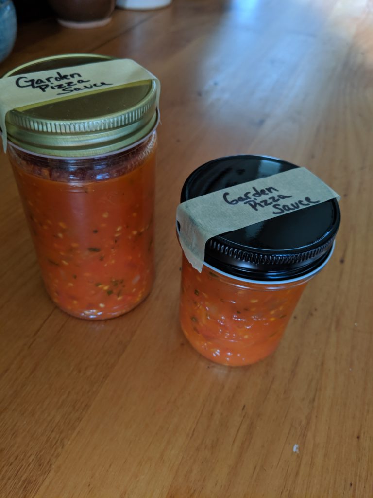 Garden marinara sauce in two jars to freeze.