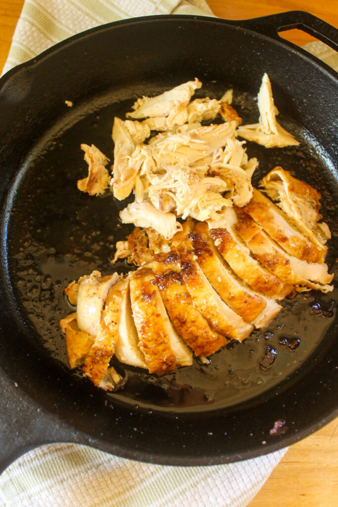 Sliced chicken breast made in a cast iron skillet.