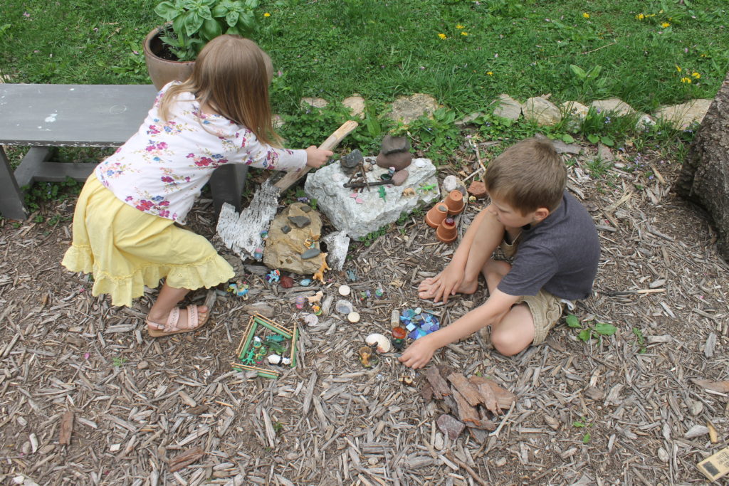 Kids building their fairy garden Kids building their fairy garden