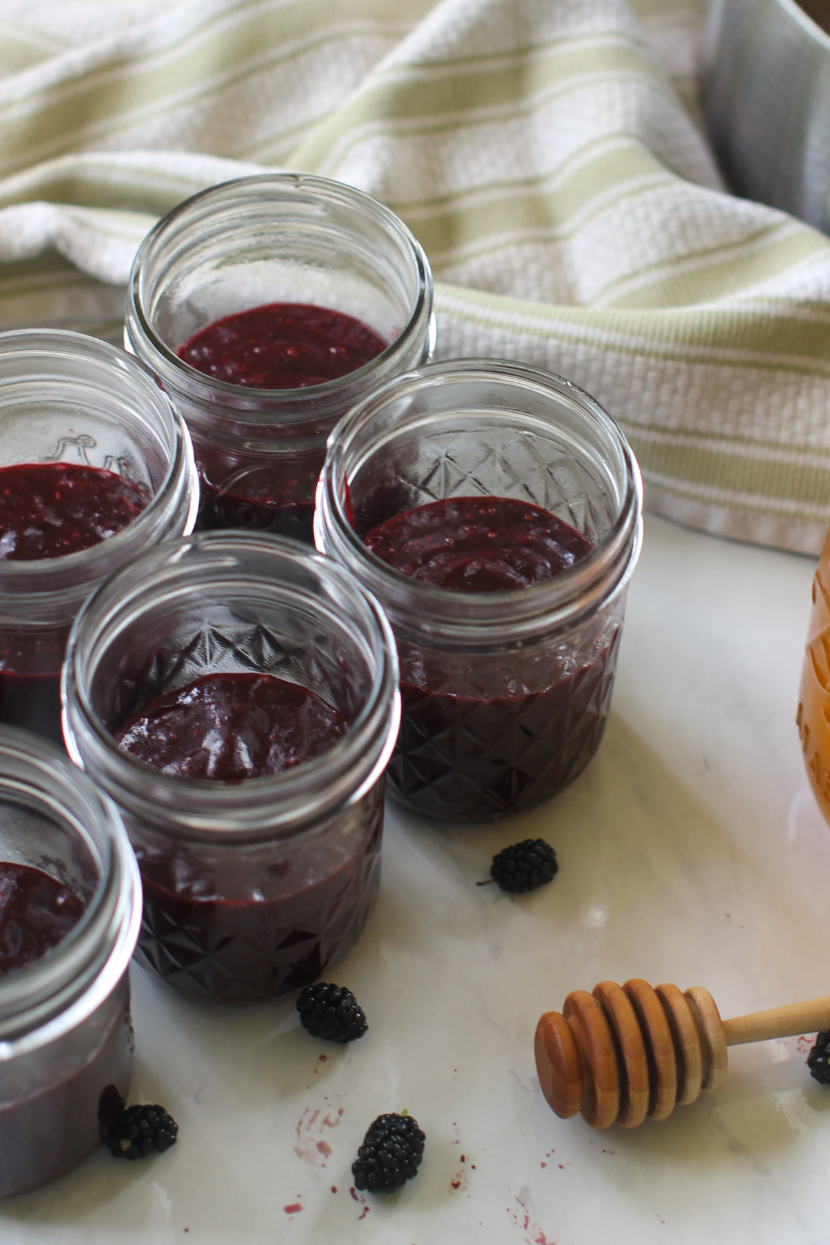 Jars filled with mulberry jam for the freezer.